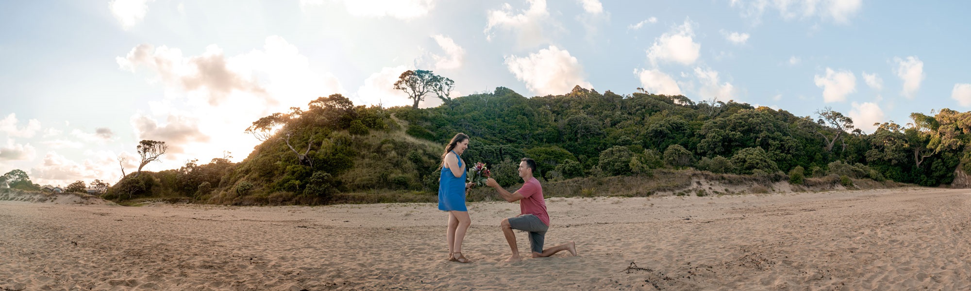 A man proposes to a woman at sunset on Matapōuri Beach, in the Whangārei District. 